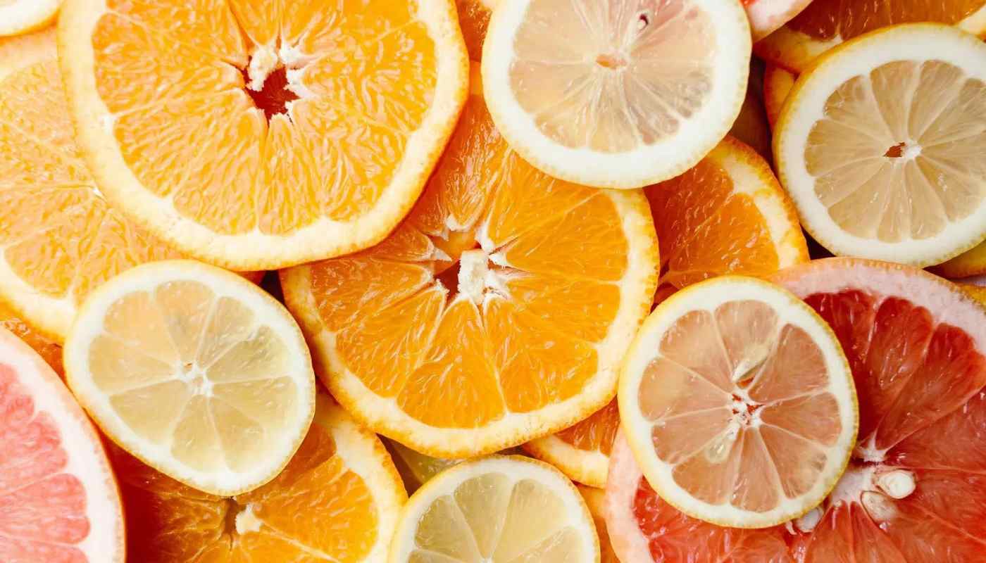 Overlapping slices of orange, lemon and grapefruit filling the frame