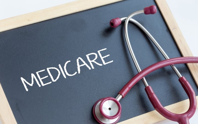 The word Medicare written in chalk on a blackboard beside a stethoscope