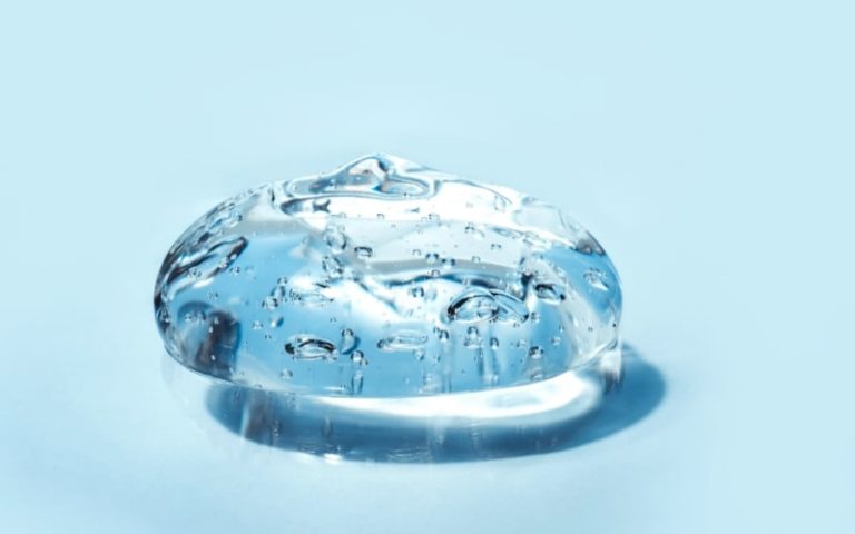 A blob of clear blue gel on a pale surface