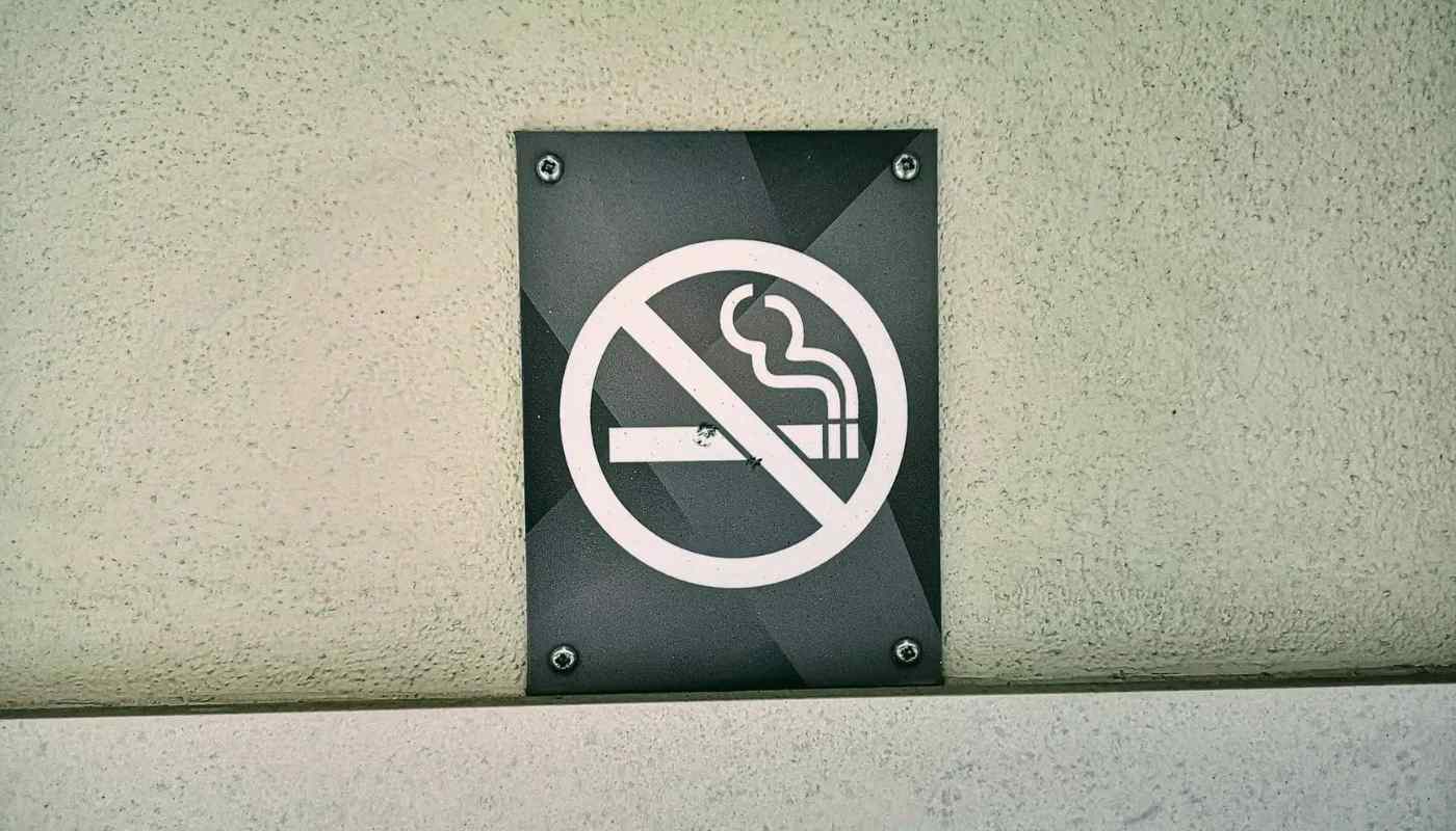 A no-smoking sign mounted on an exterior wall