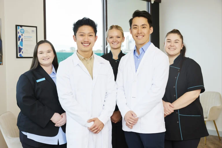 The Dove Dental Waurn Ponds team of dentists and support staff standing together in the clinic